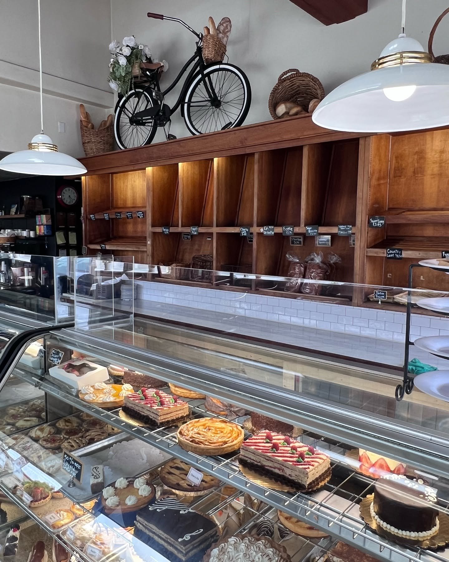 Inside Paris Bakery with vintage bicycle and wooden bread shelves